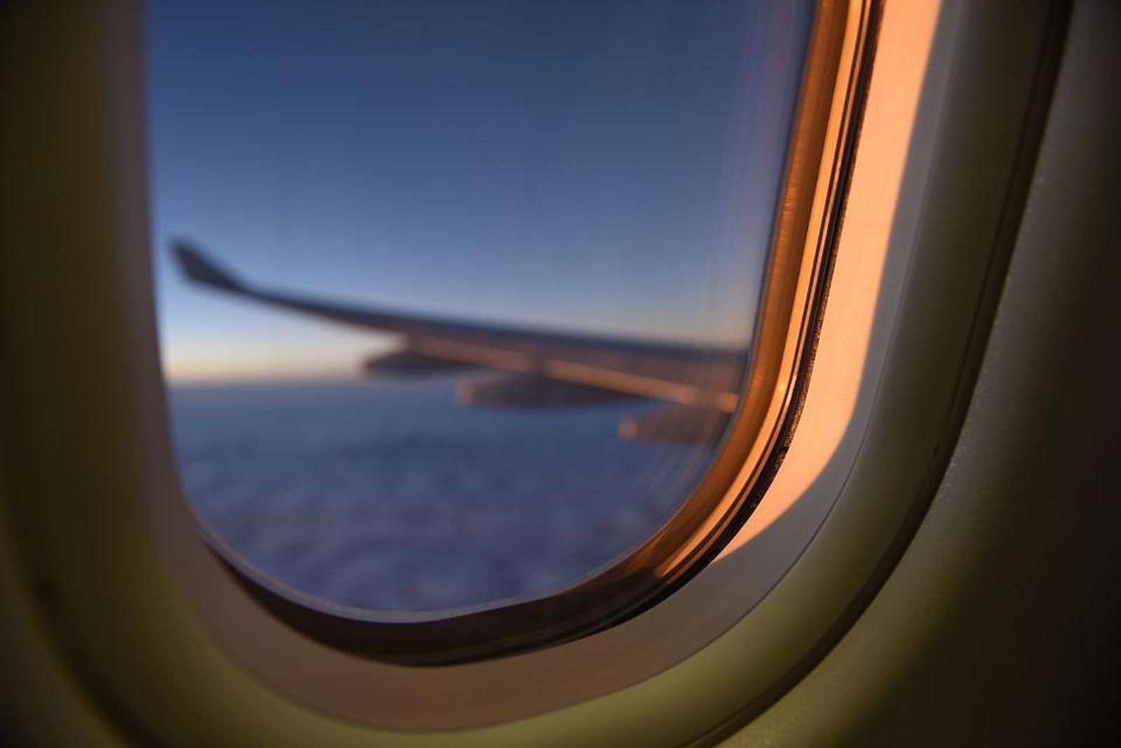 The view from an aircraft window at golden hour