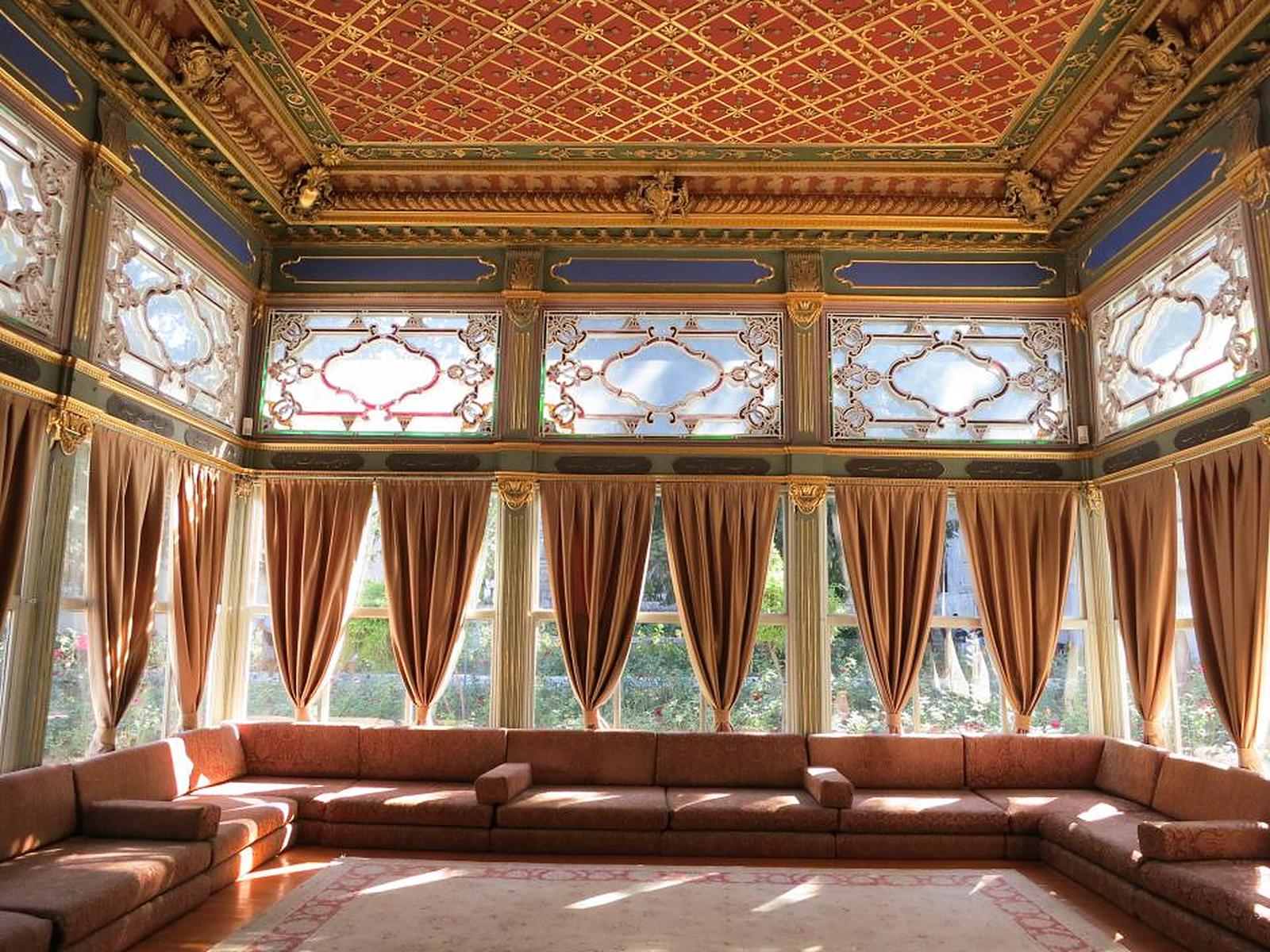 An ornate palace salon with tall windows