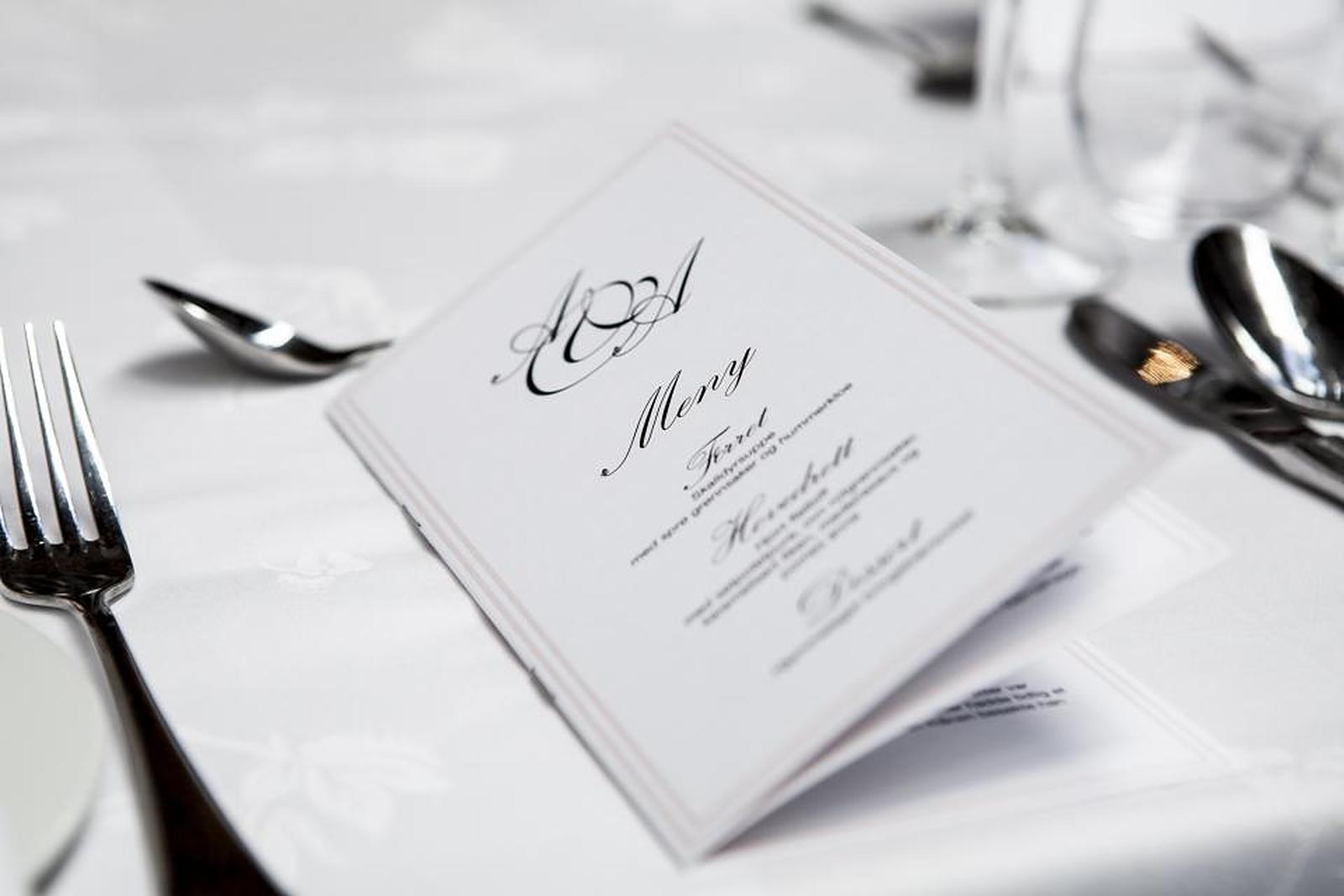 A formal dinner place setting with a printed menu